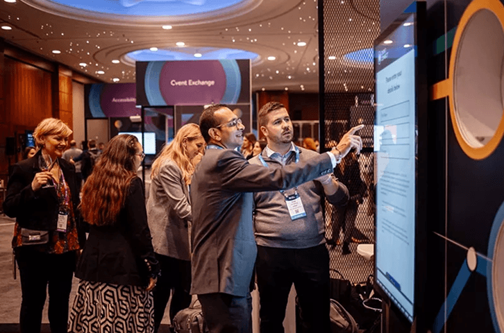 People interacting with a large digital event screen